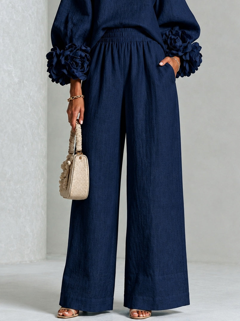 María | Top azul marino con llamativos puños florales, combinado con un traje de pantalón de corte ancho